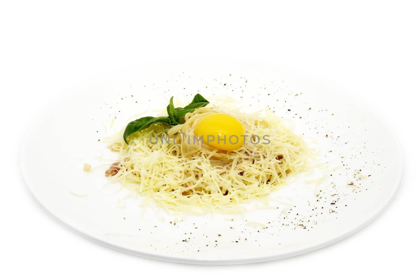spaghetti with egg on a plate on a white background