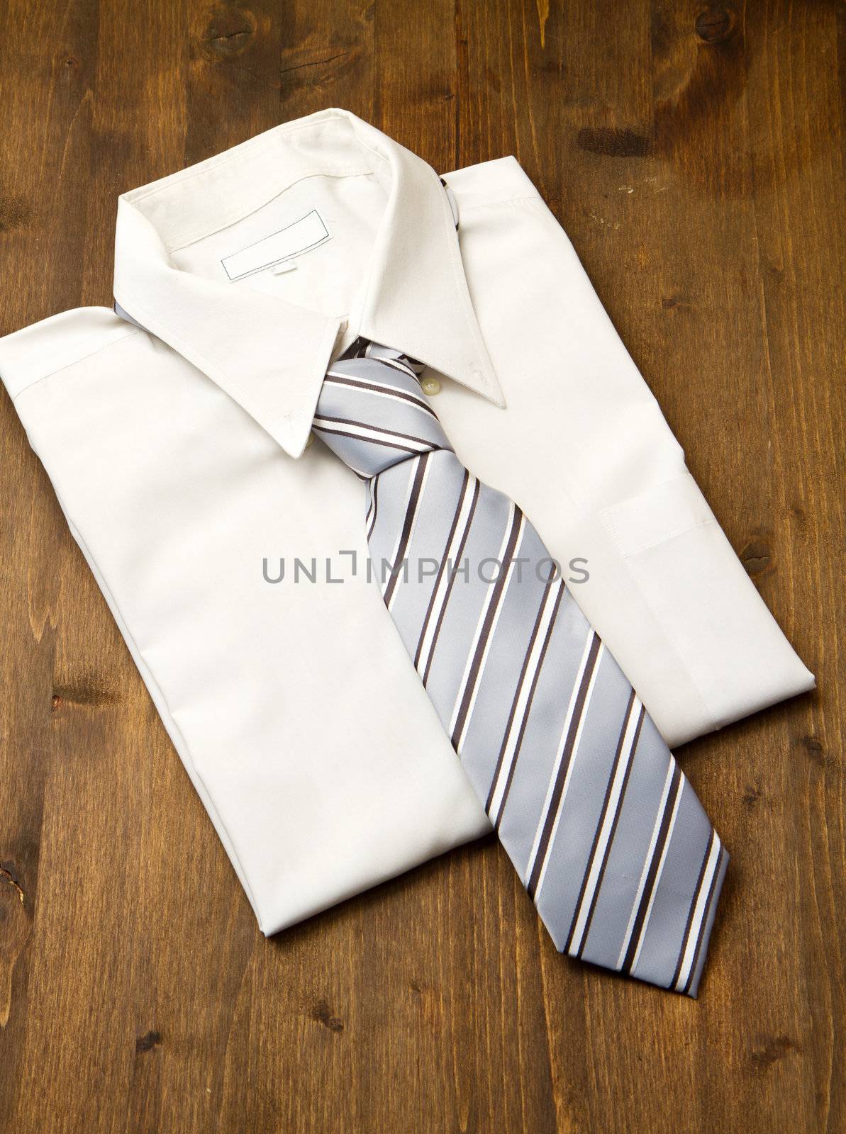 New white man's shirt and tie isolated on wood