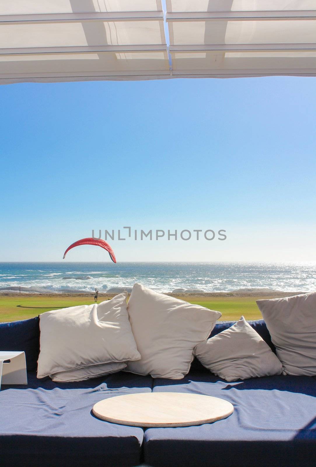 Beach club couch with ocean in the background