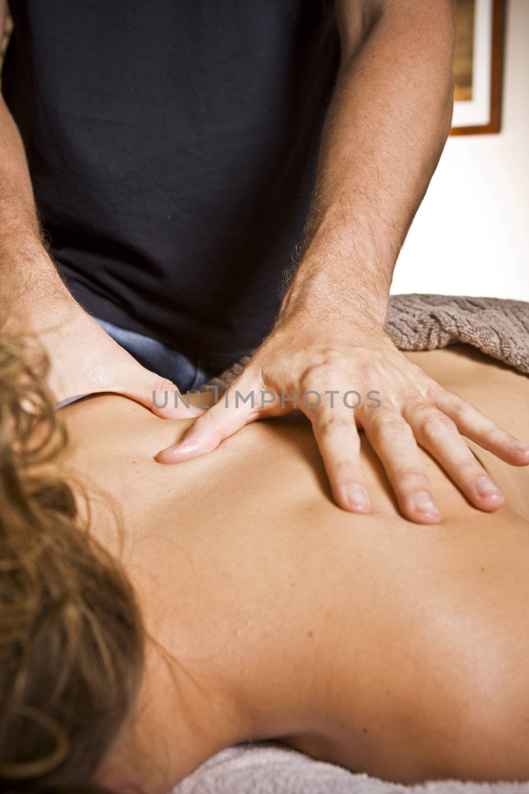 Close up naked young lady getting back massage at spa