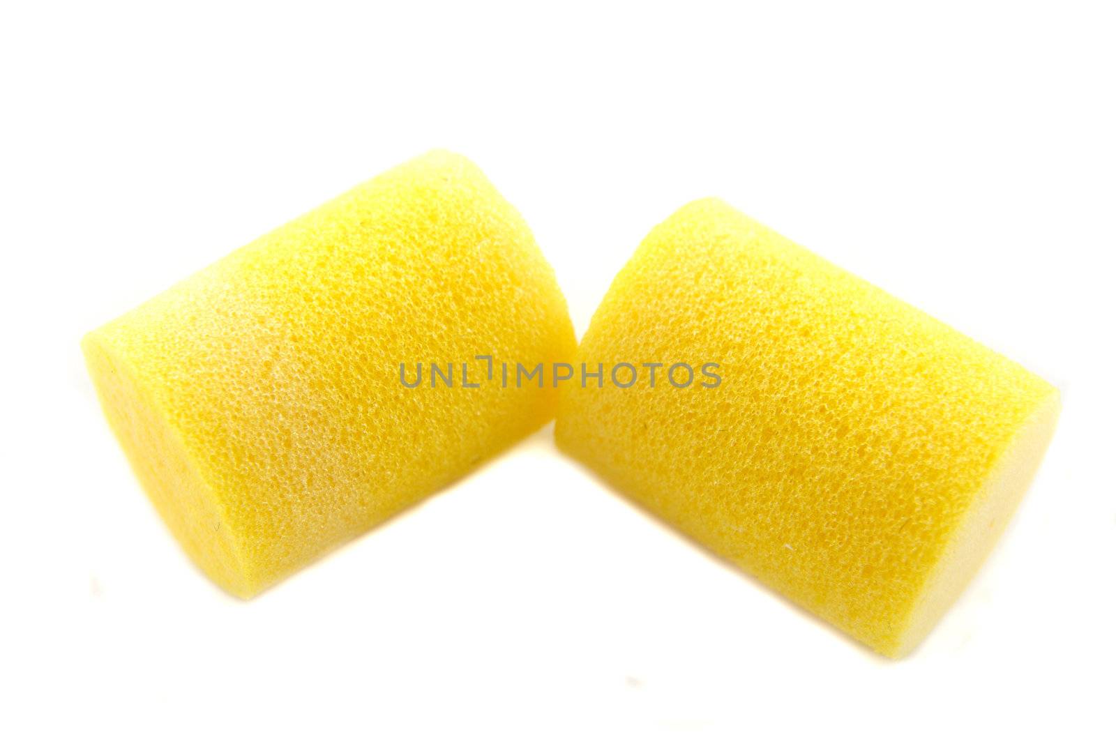 yellow ear plugs on a white background
