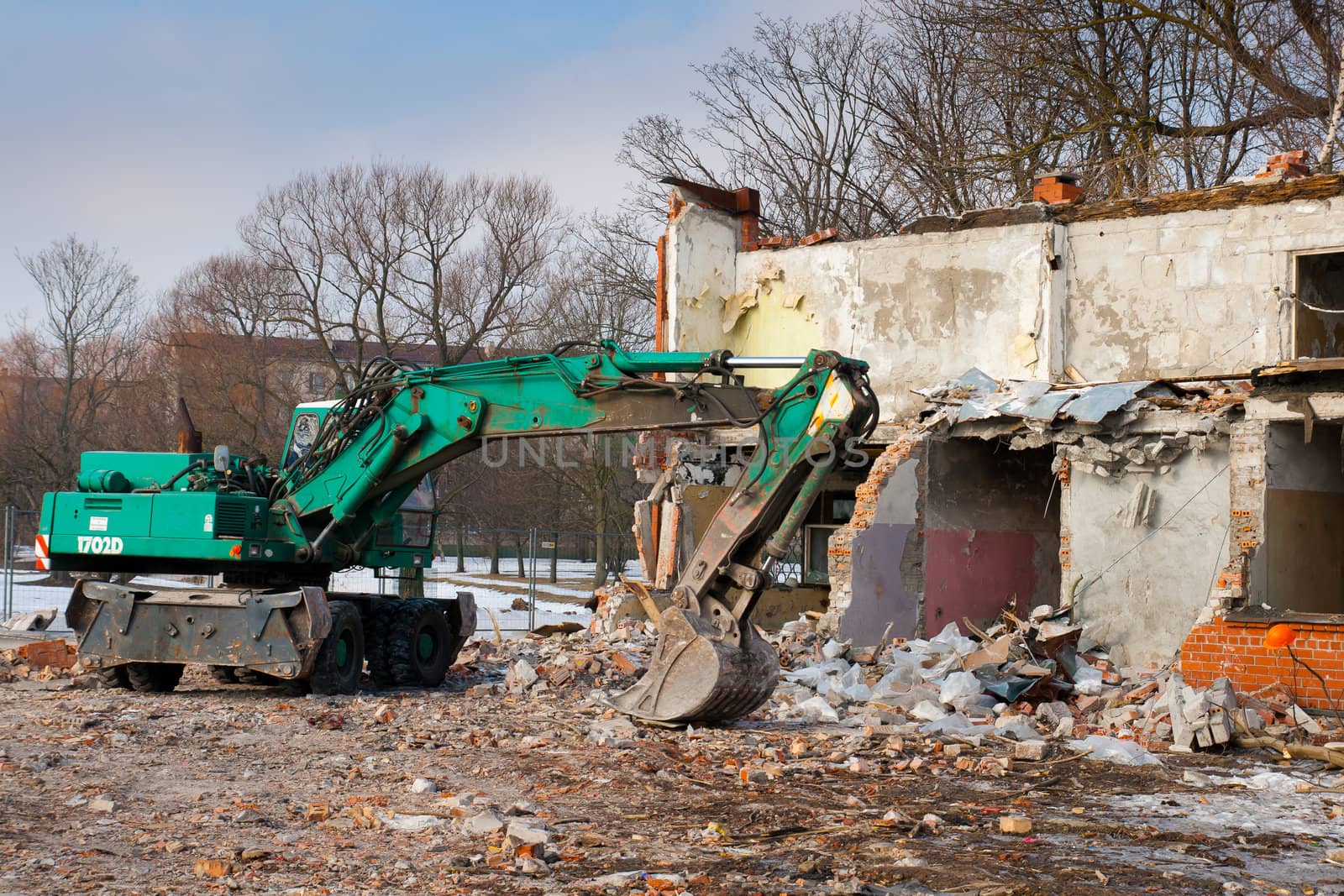 excavator at the abandoned demolished home