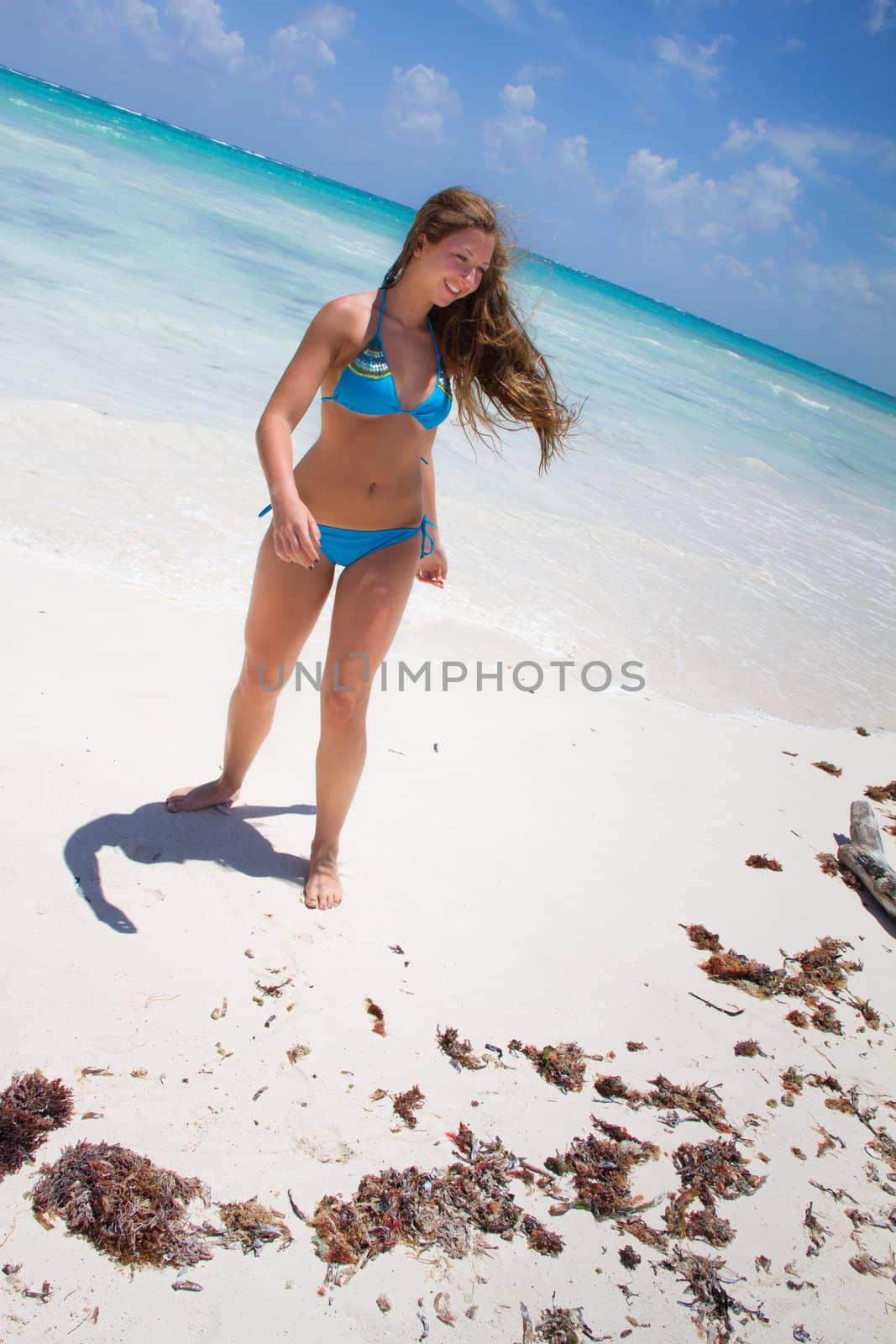Young beautiful women on a tropical beach by DeborahKolb