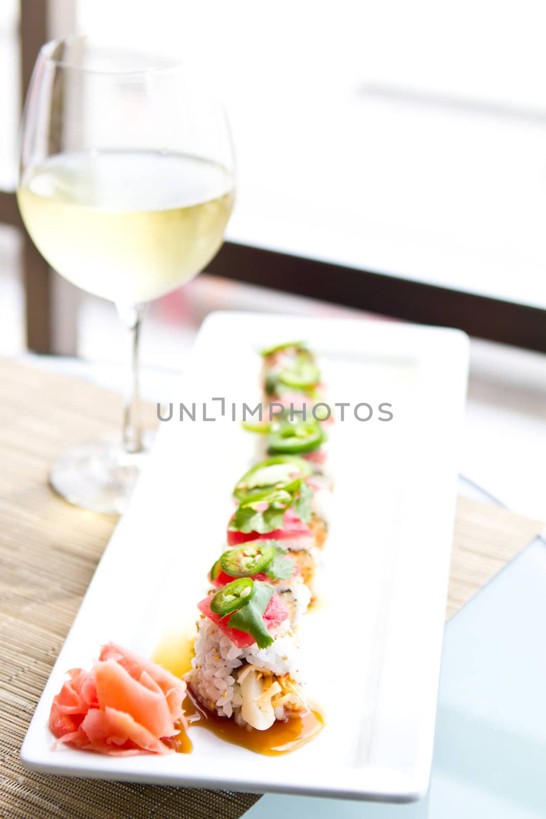 Sushi with tuna and a glass of White Wine