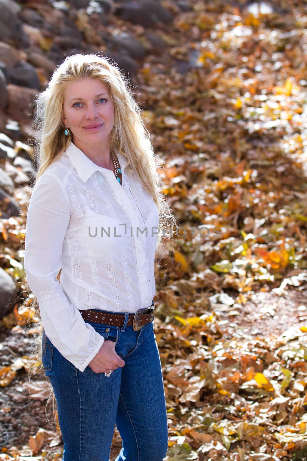 Pretty Woman with Long Hair in fall leaves