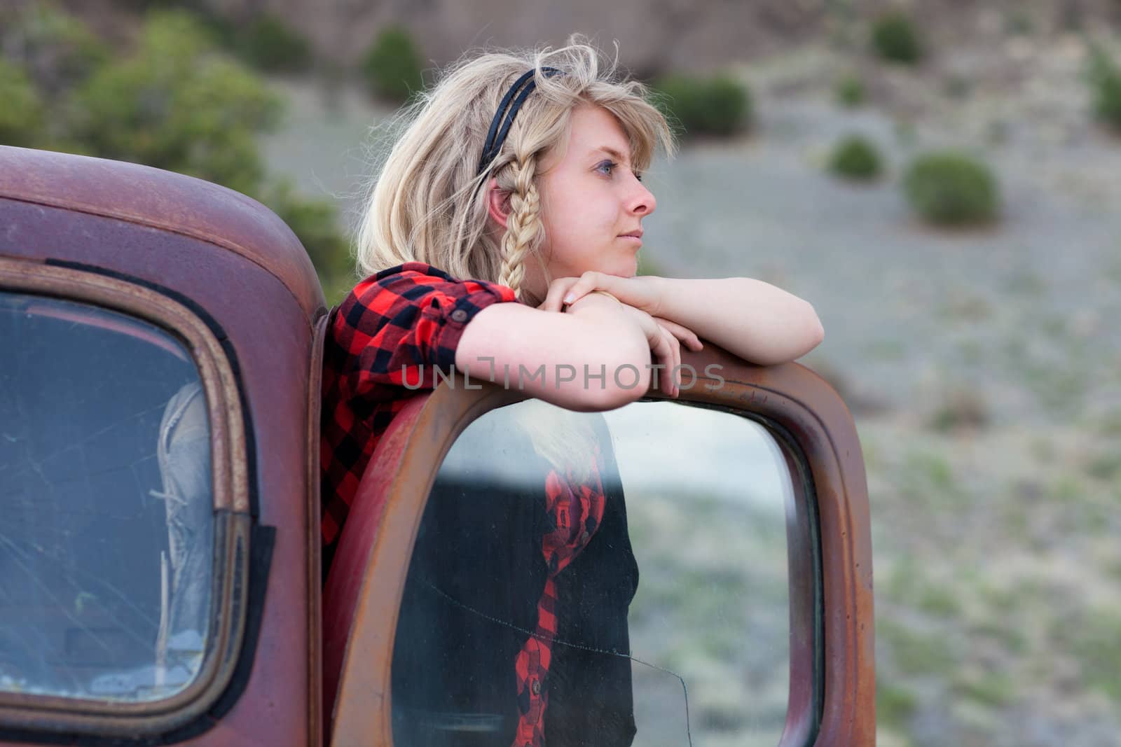 Pretty Blonde Girl in a Vintage old truck deep thought