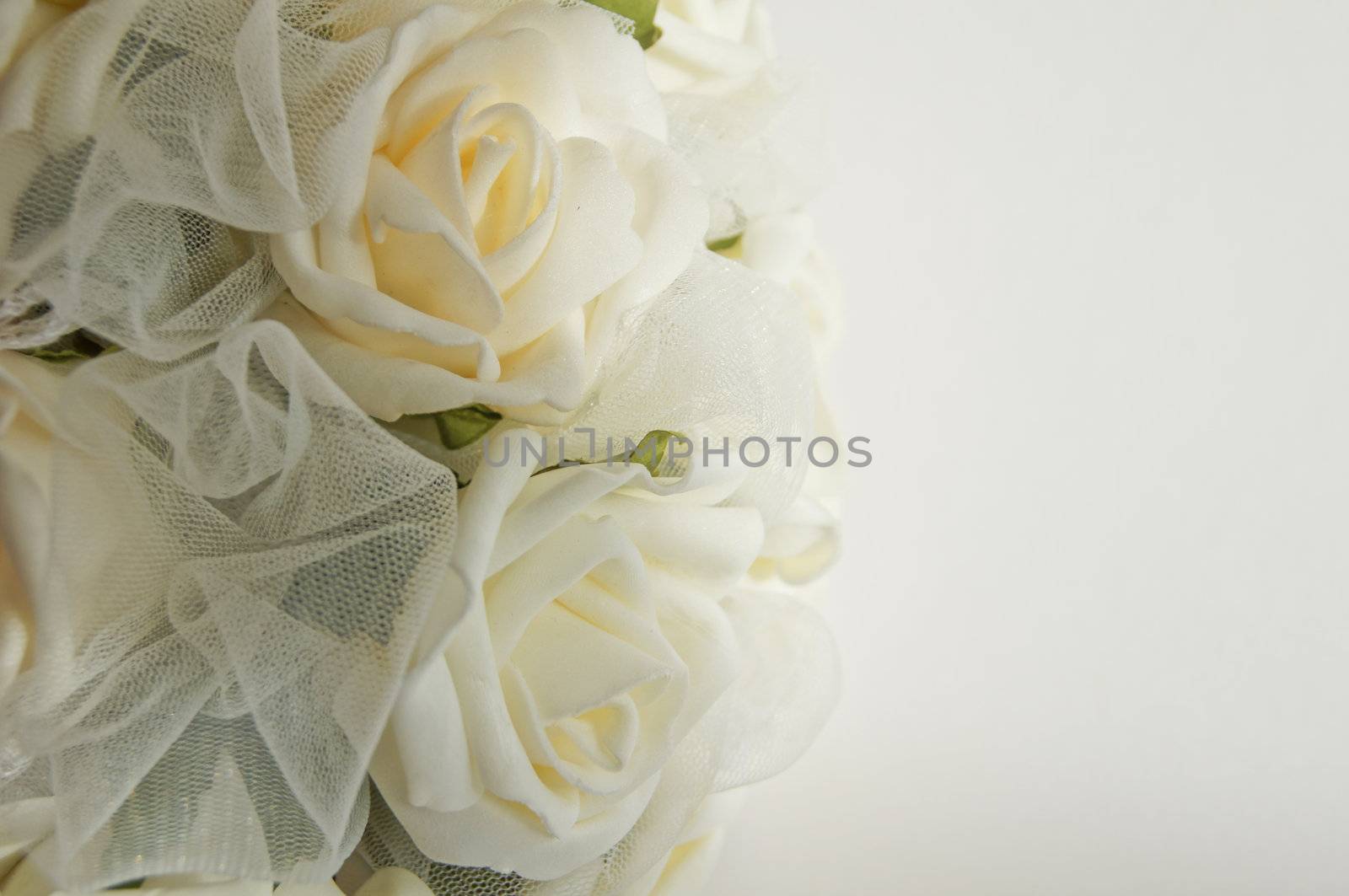 Wedding decoration - white roses bouquet, rings, bride and groom