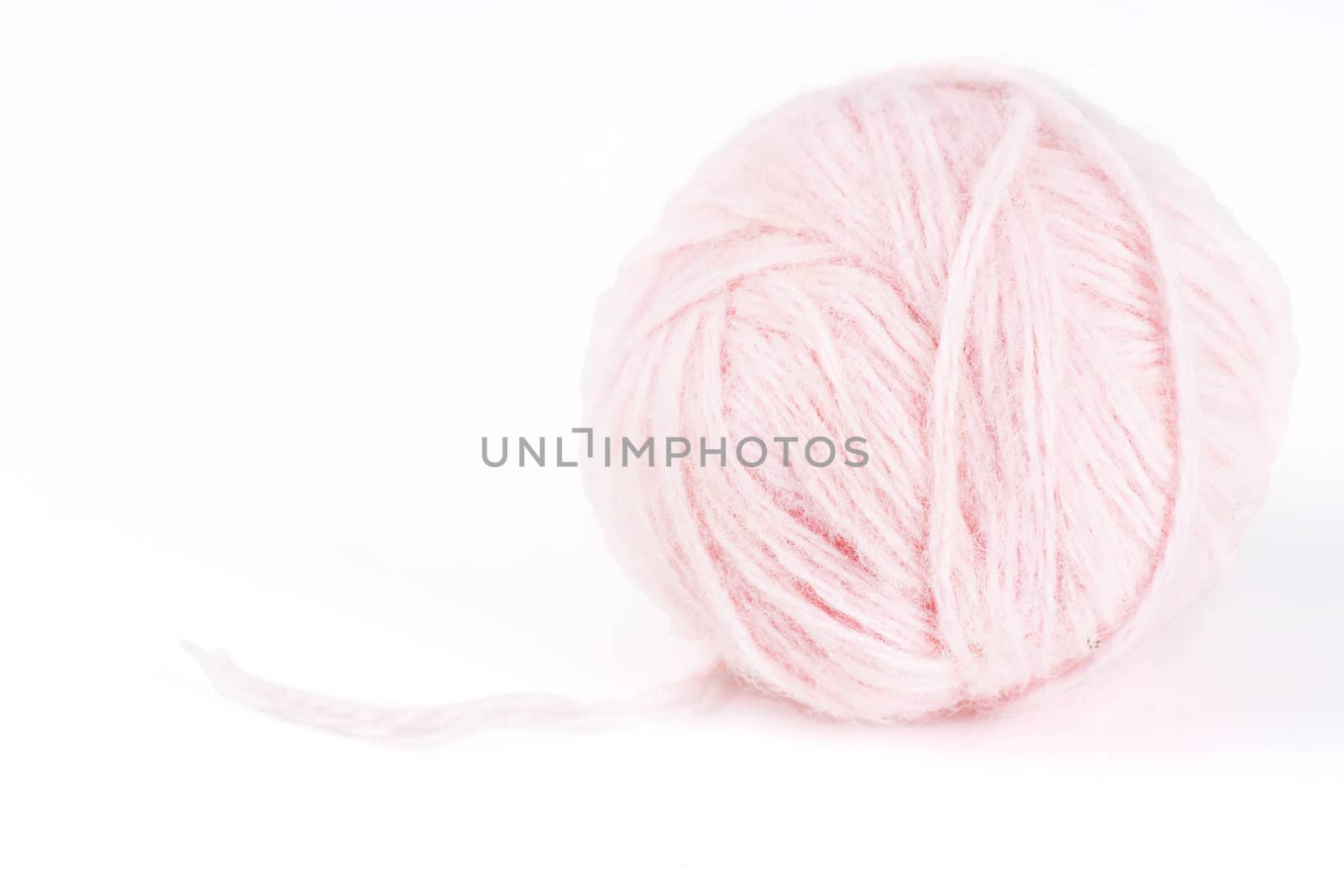 Macro shot of ball of pretty soft pale pink angora wool or yarn, great craft or baby girl background.
