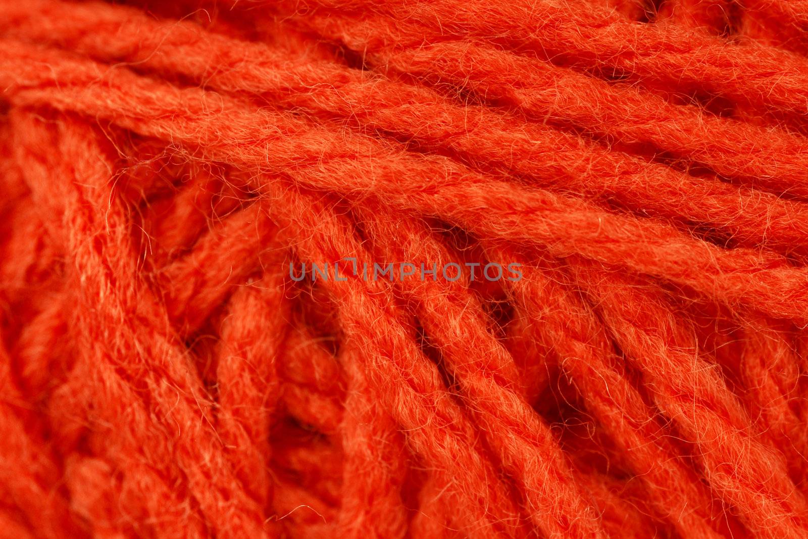 Macro shot of orange yarn or wool by Mirage3