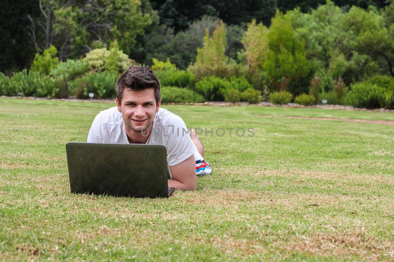 Man working on Notebook outdoors in park