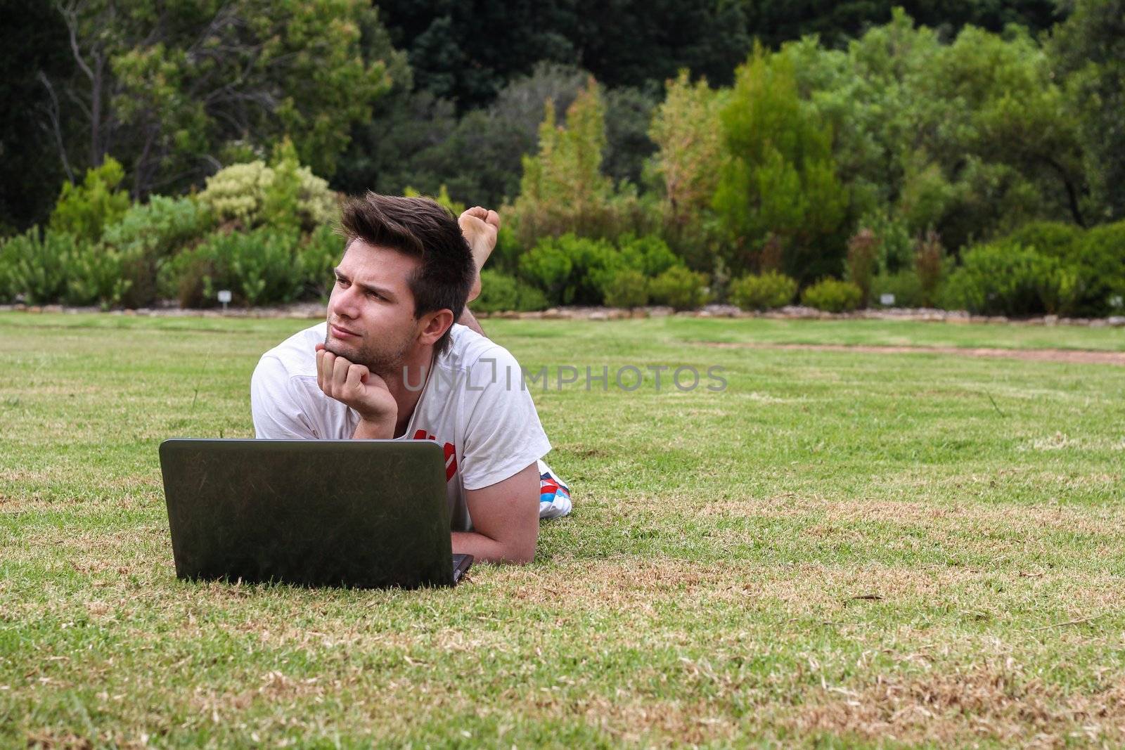 Man working on Notebook outdoors in park