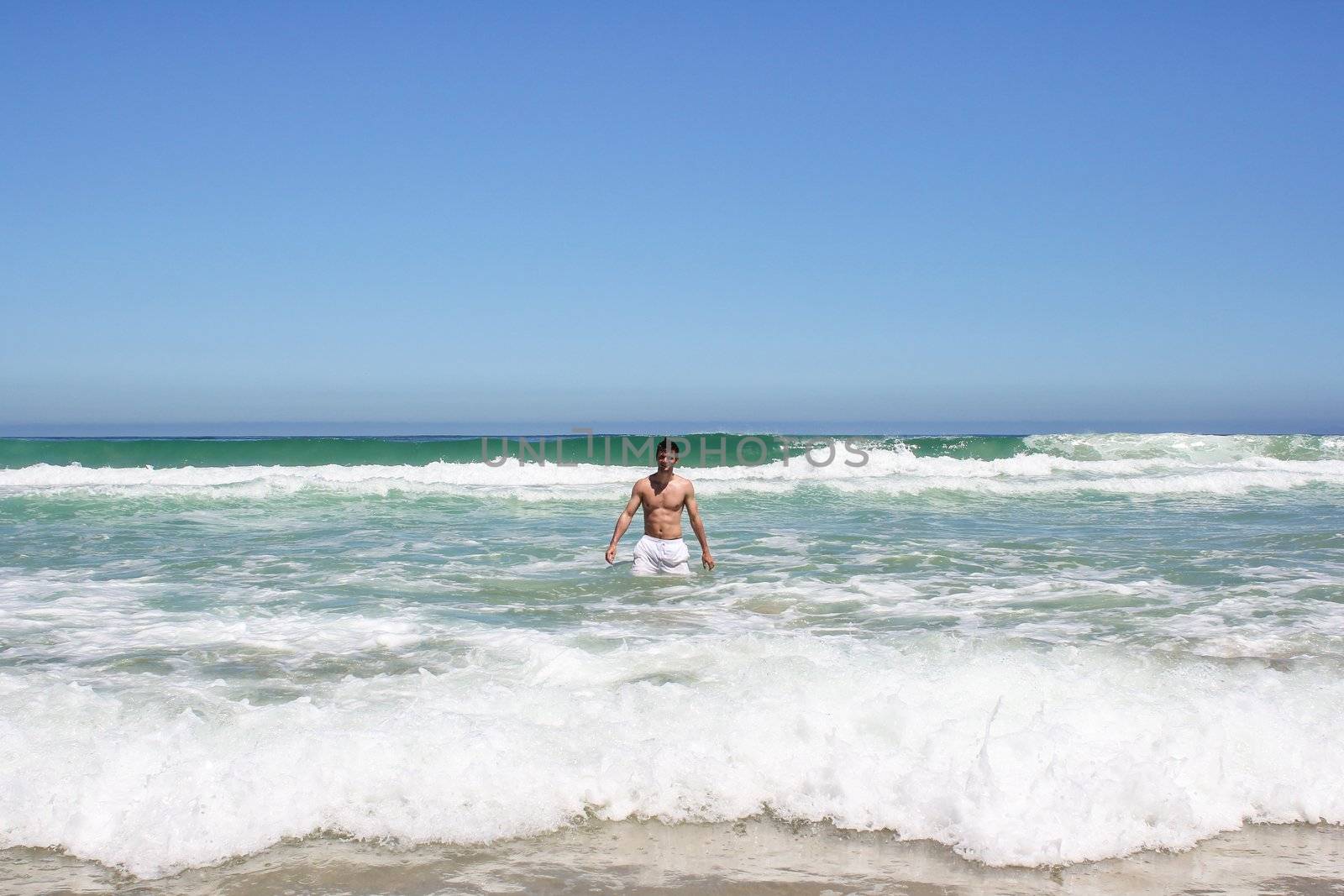 Man standing in indian ocean in south africa