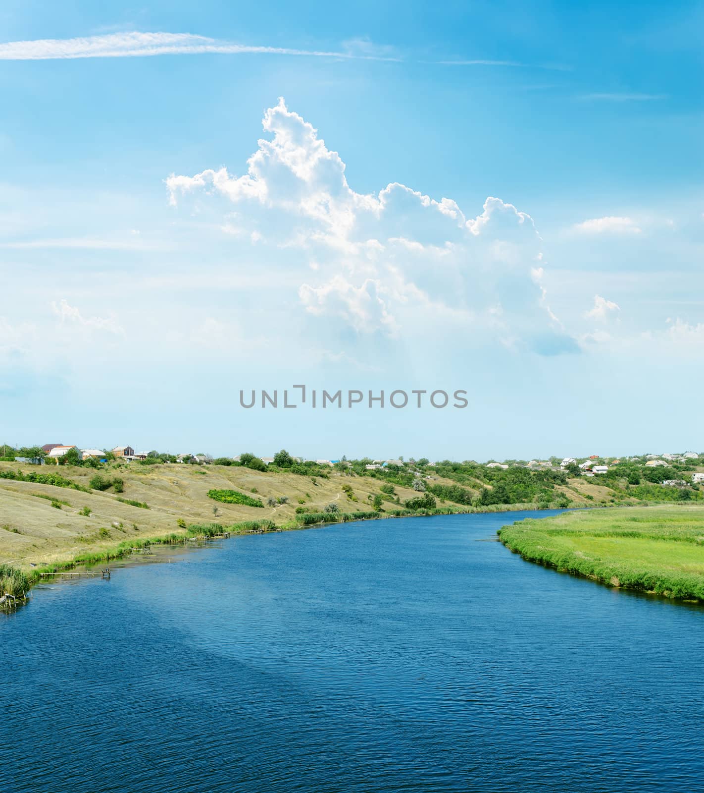 river and light clouds over it by mycola