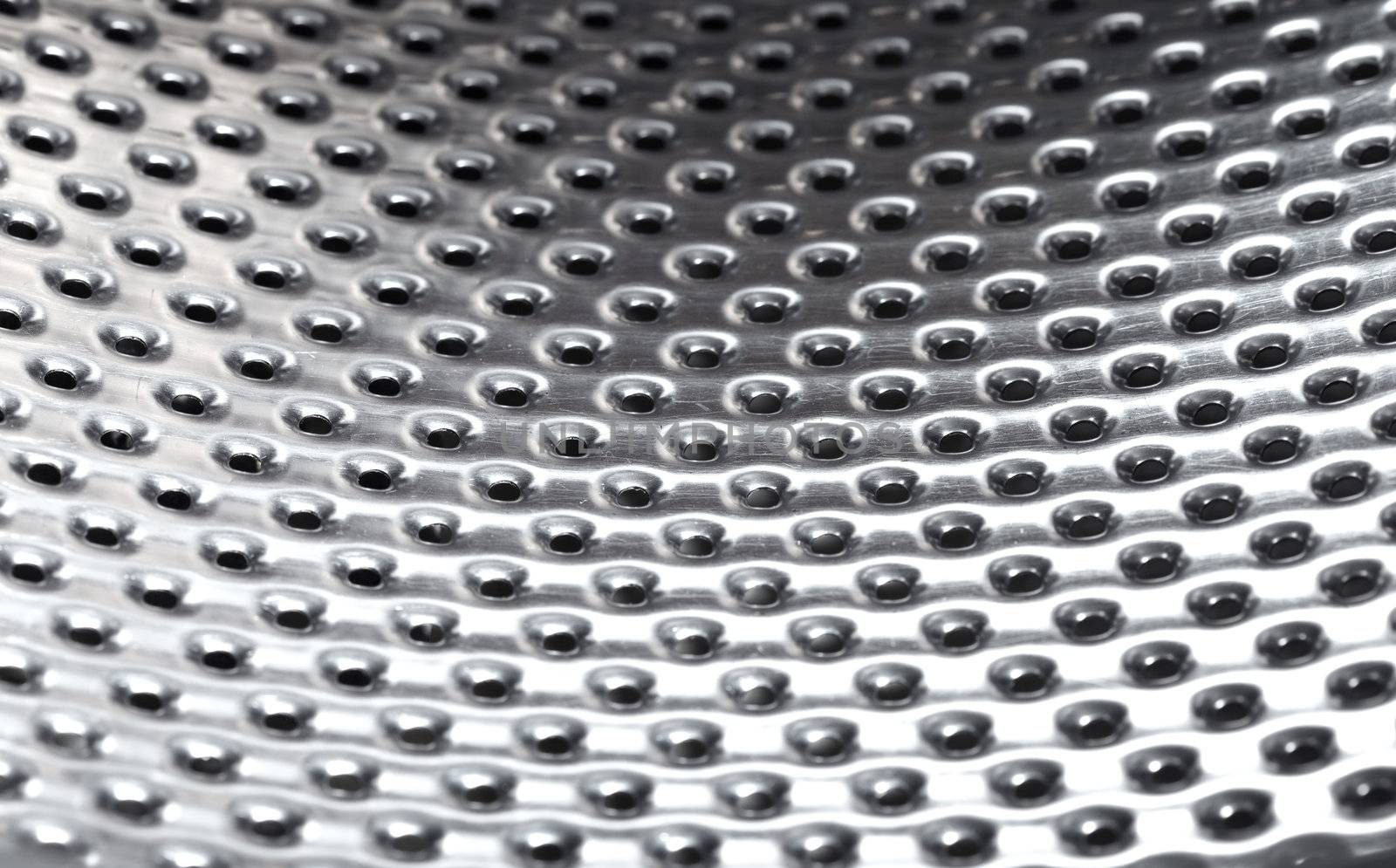 Close-up photo of the metal pattern with perforated holes