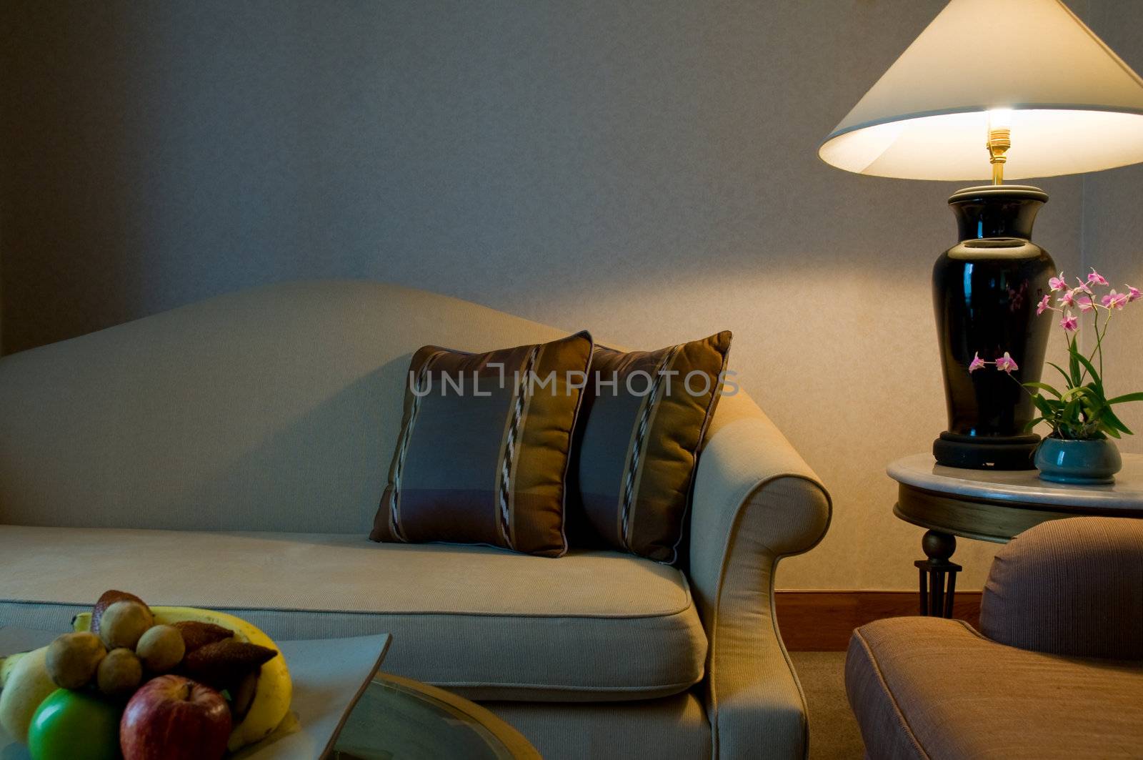 Sitting area of a 5 star luxury hotel suite room, with fruit and orchids