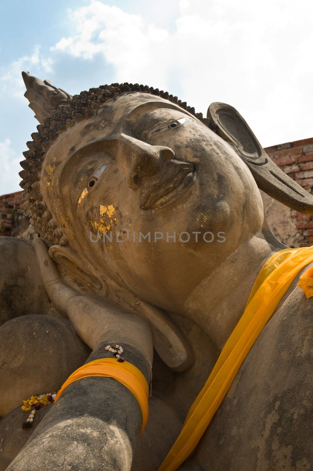 Face of a reclining Buddha. Ayutthaya city is the capital of Ayutthaya province in Thailand. Its historical park is a UNESCO world heritage.