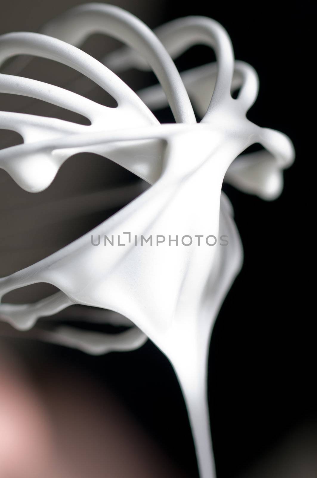 Whisk with creamy egg white close up  by 3523Studio