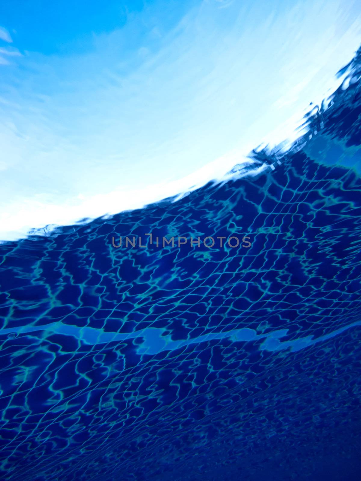 Swimming pool picture from below water surface, beautiful blue color