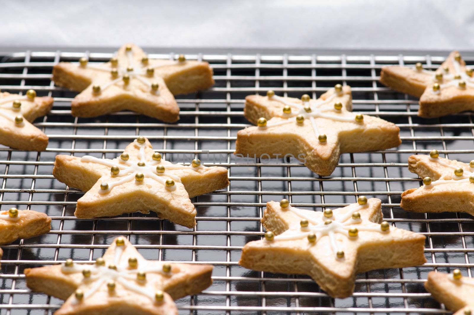 Decorated star shape christmas cookies on the backing tray