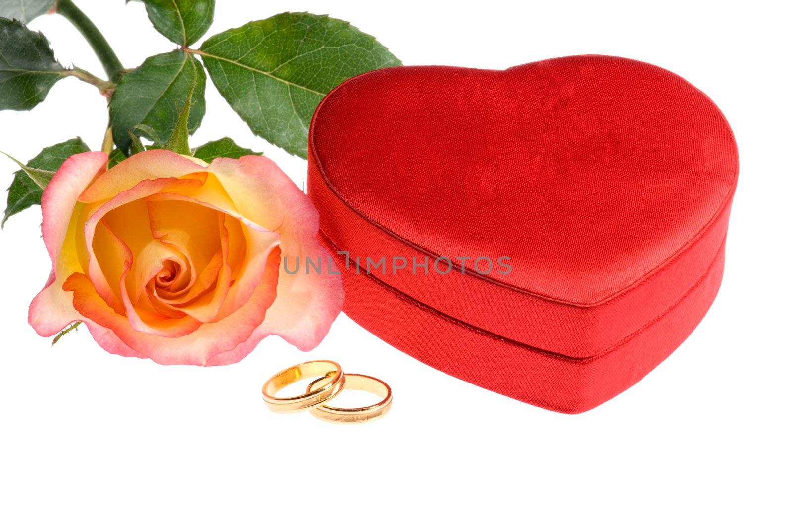 red yellow rose wedding rings and heart shape box over white