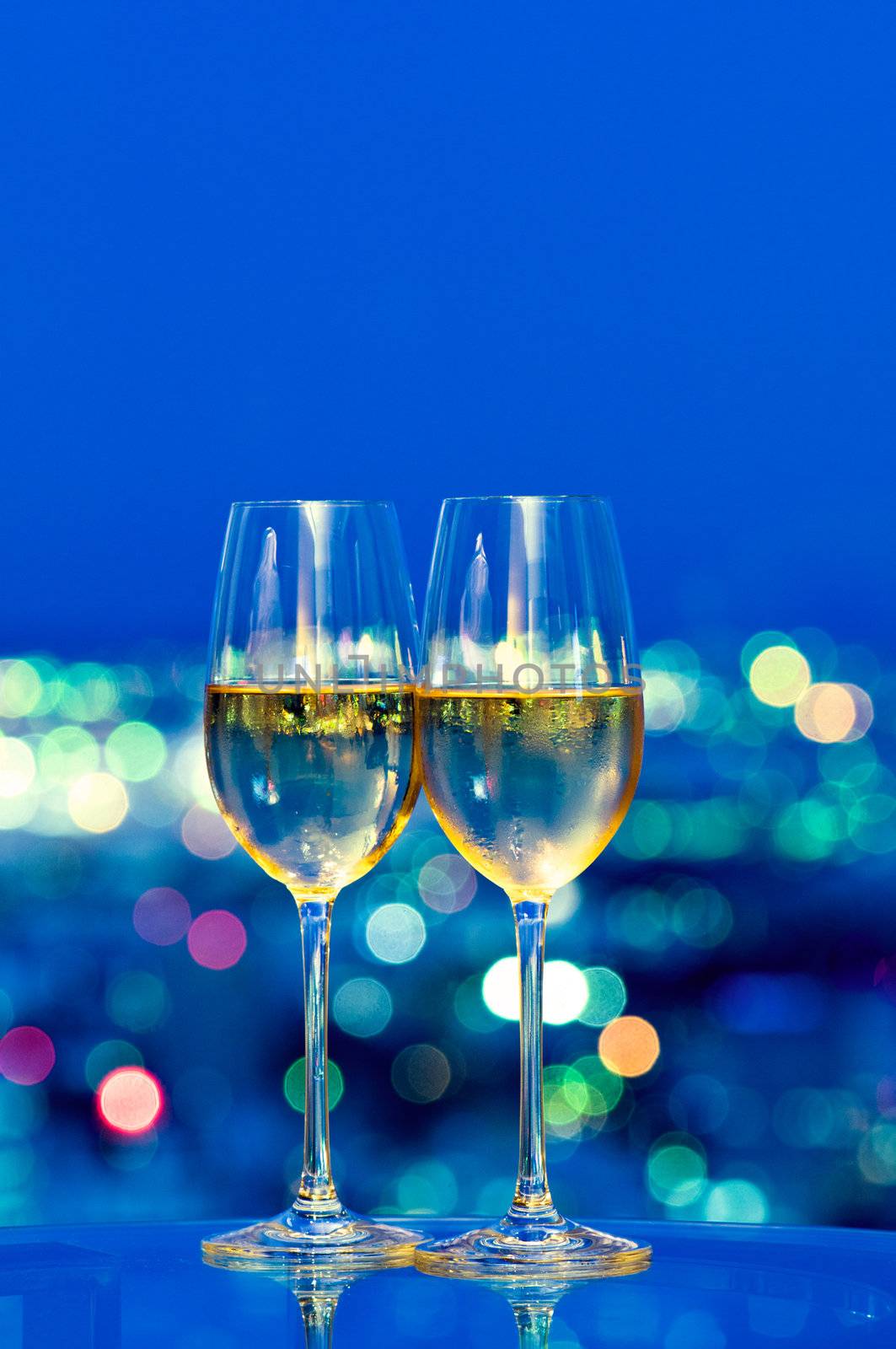 Champagne glasses in front of a window in the night sky