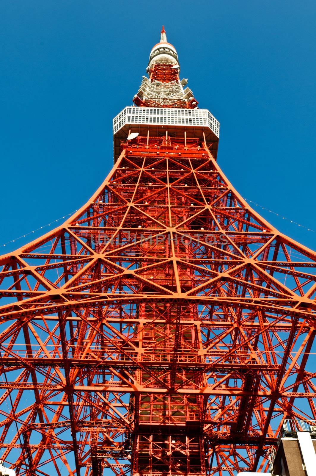 Tokyo tower faces blue sky with no clouds