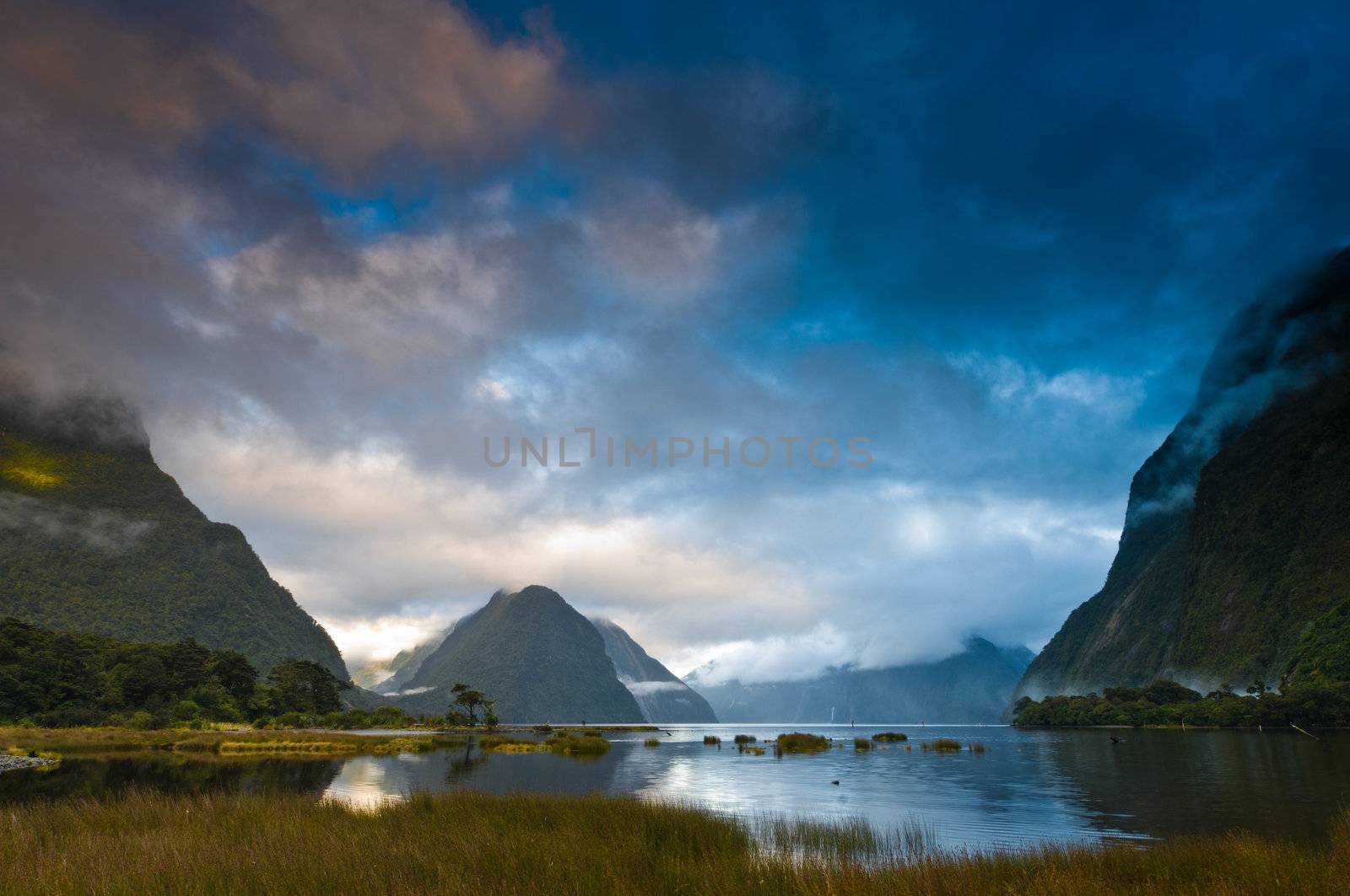 Cloudy morning at milford sound with sunrise in the back ground