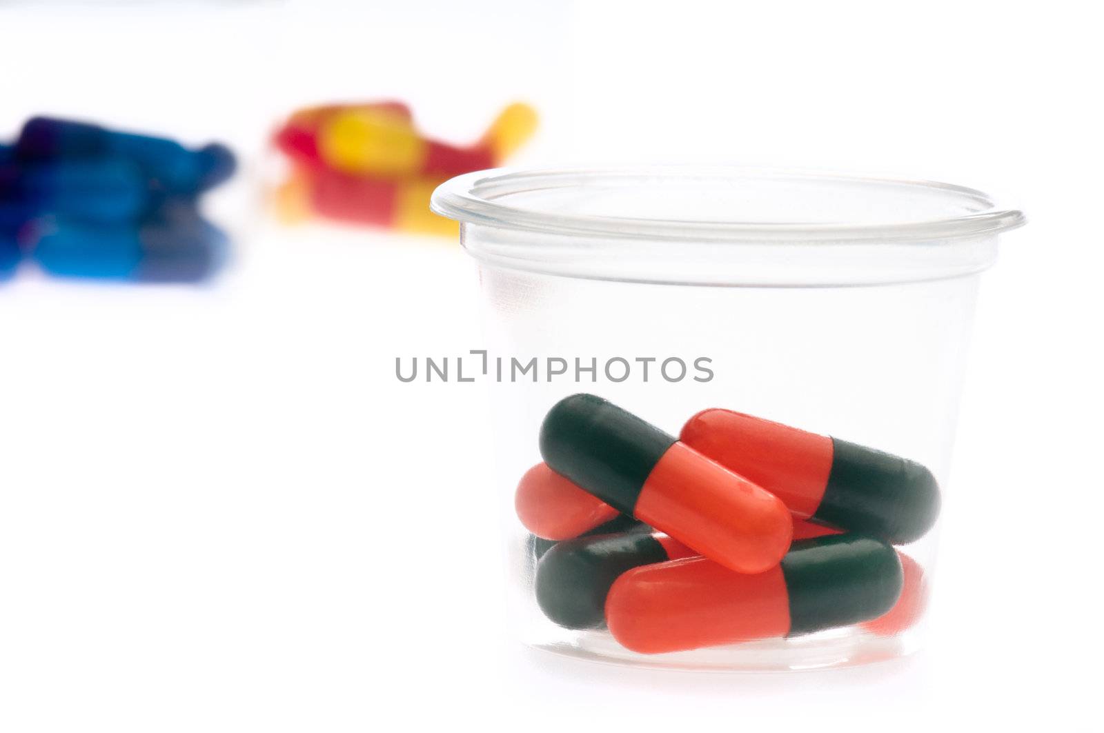 Colorful tablets, capsules in a cup by 3523Studio