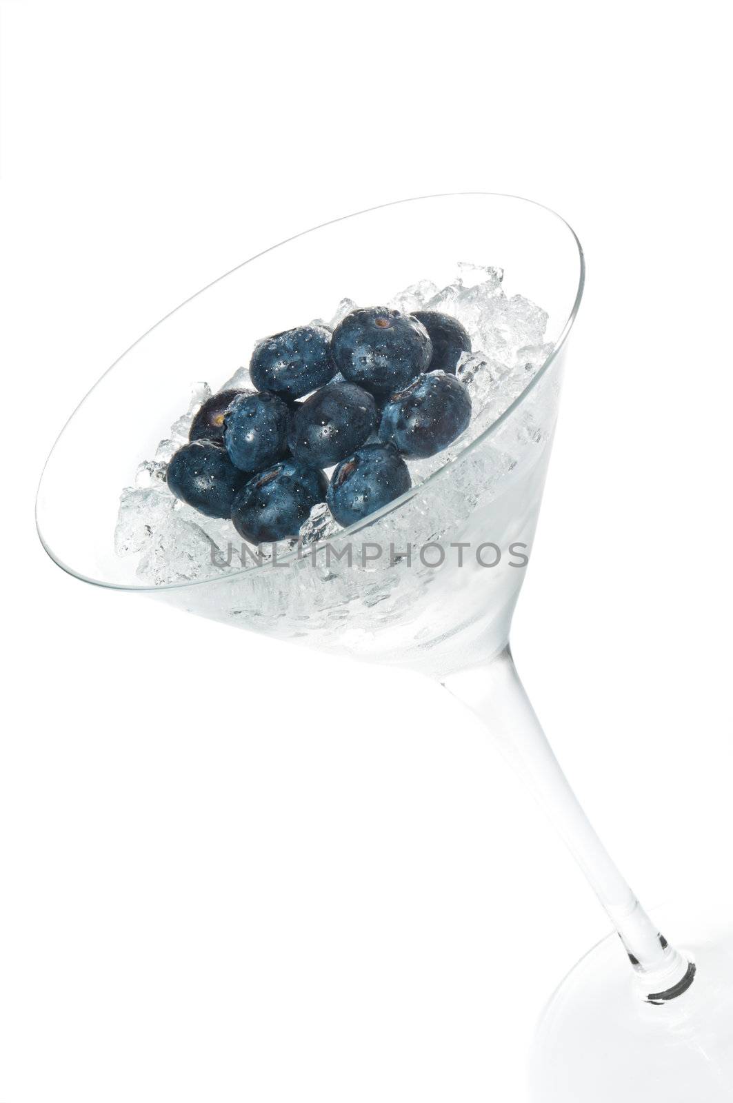 Blueberry cocktail in a martini glass over white