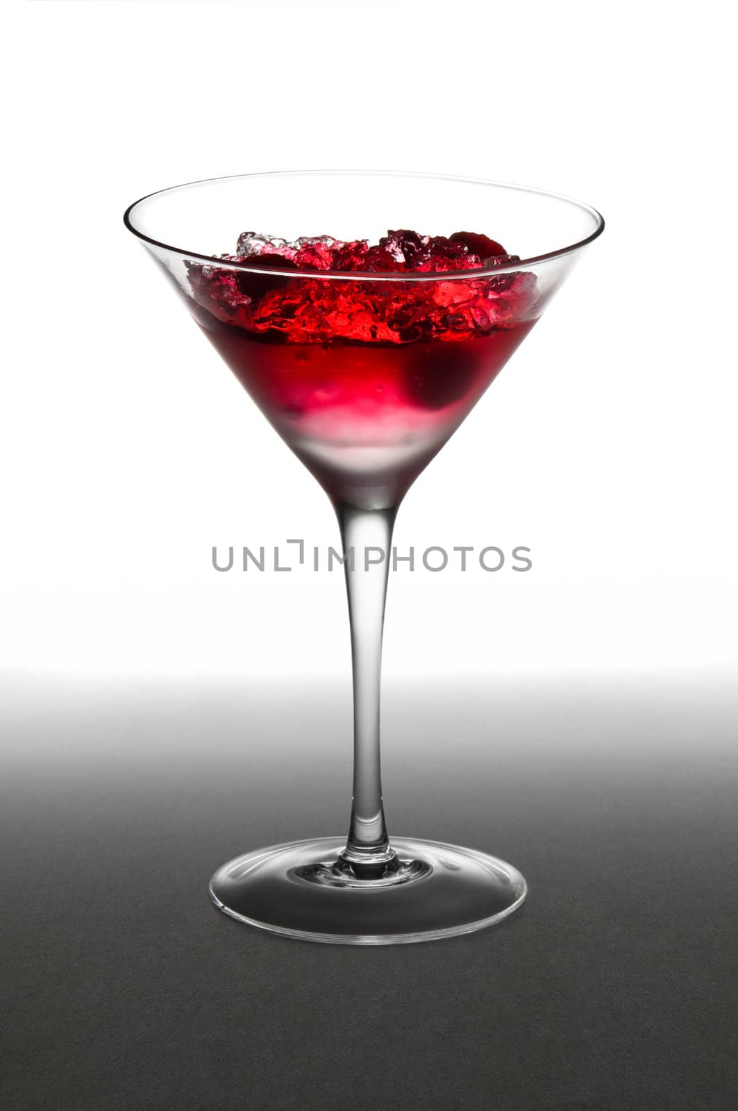 Raspberry cocktail in a martini glass, over white