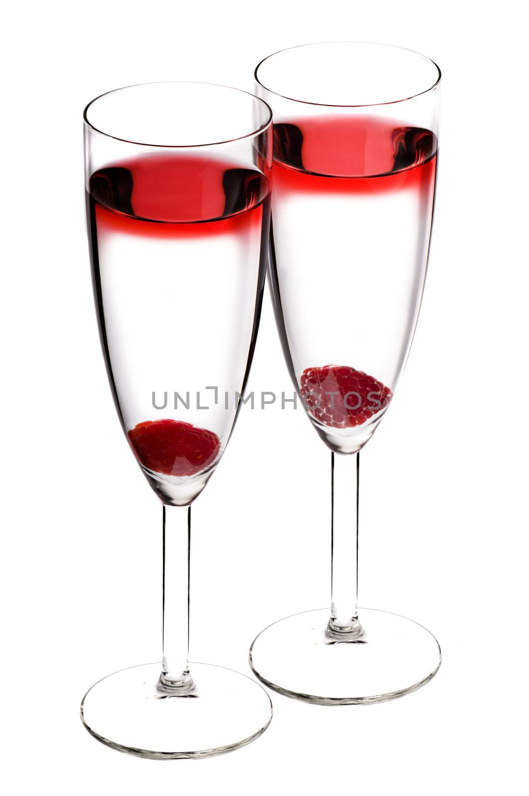 Designer cocktail isolated over white with raspberry in Champaign flute