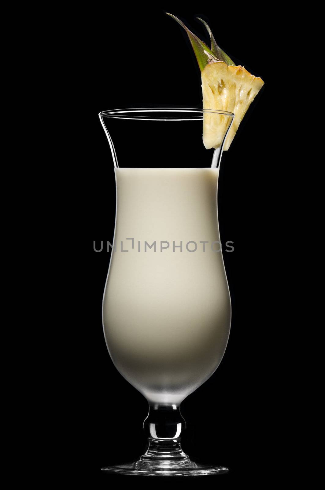 Pina colada over black in a beautiful long drink glass