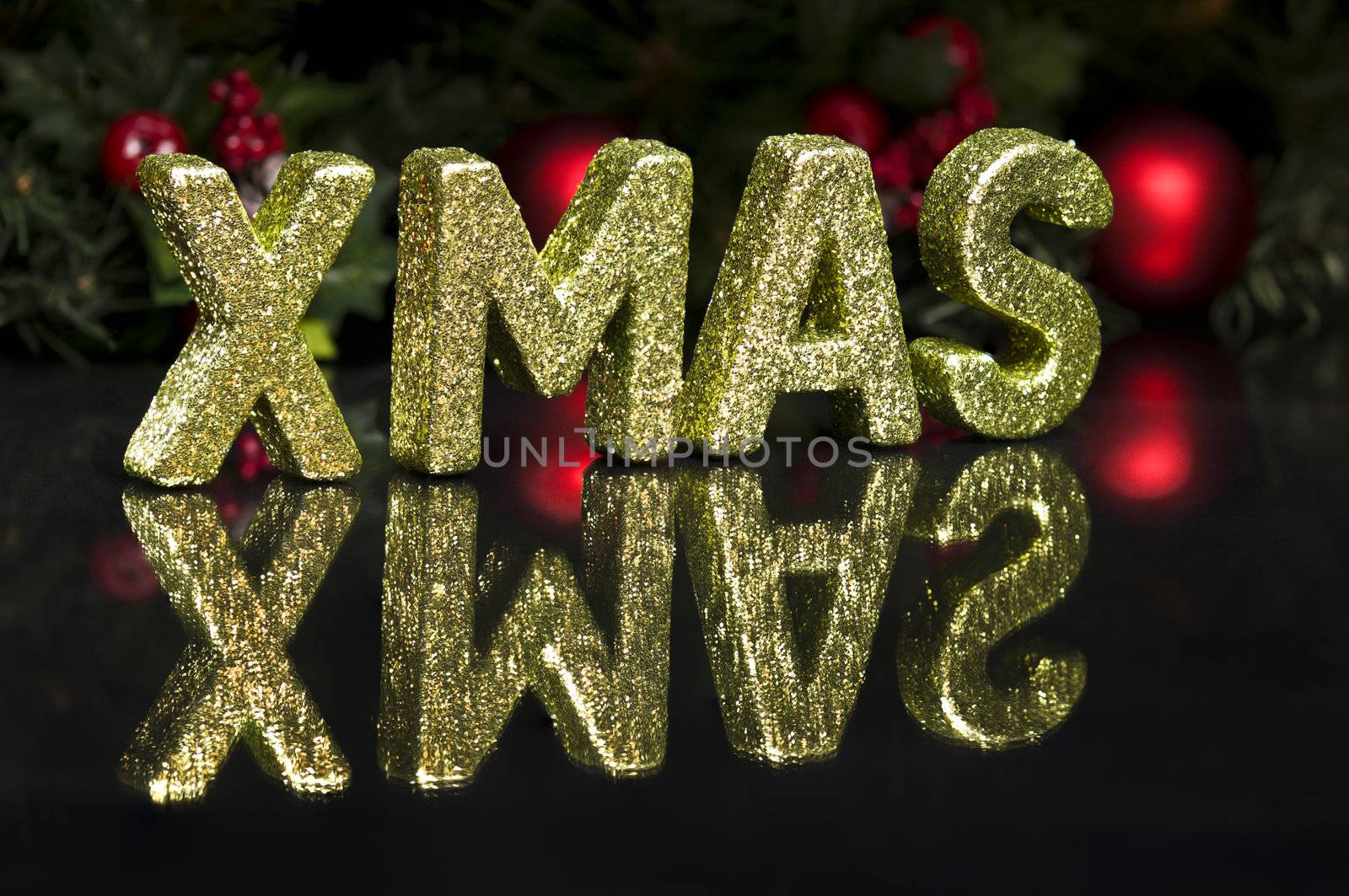 In capital letter written Xmas, glitter effect over black