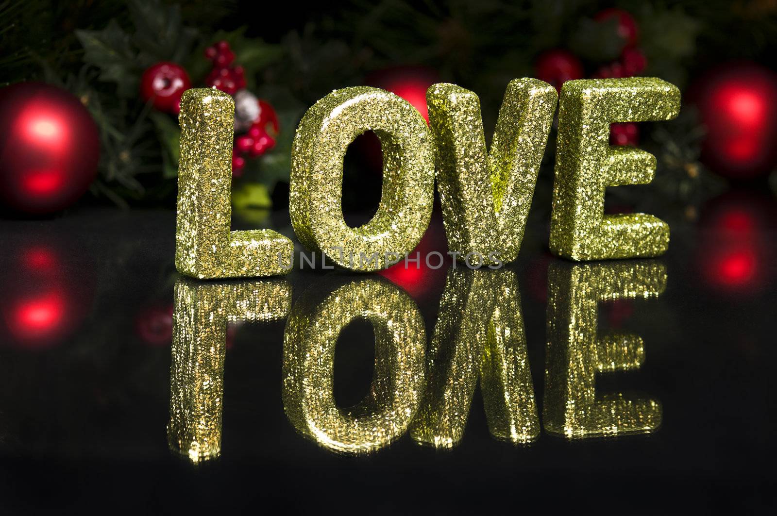 In capital letter written love, glitter effect over black