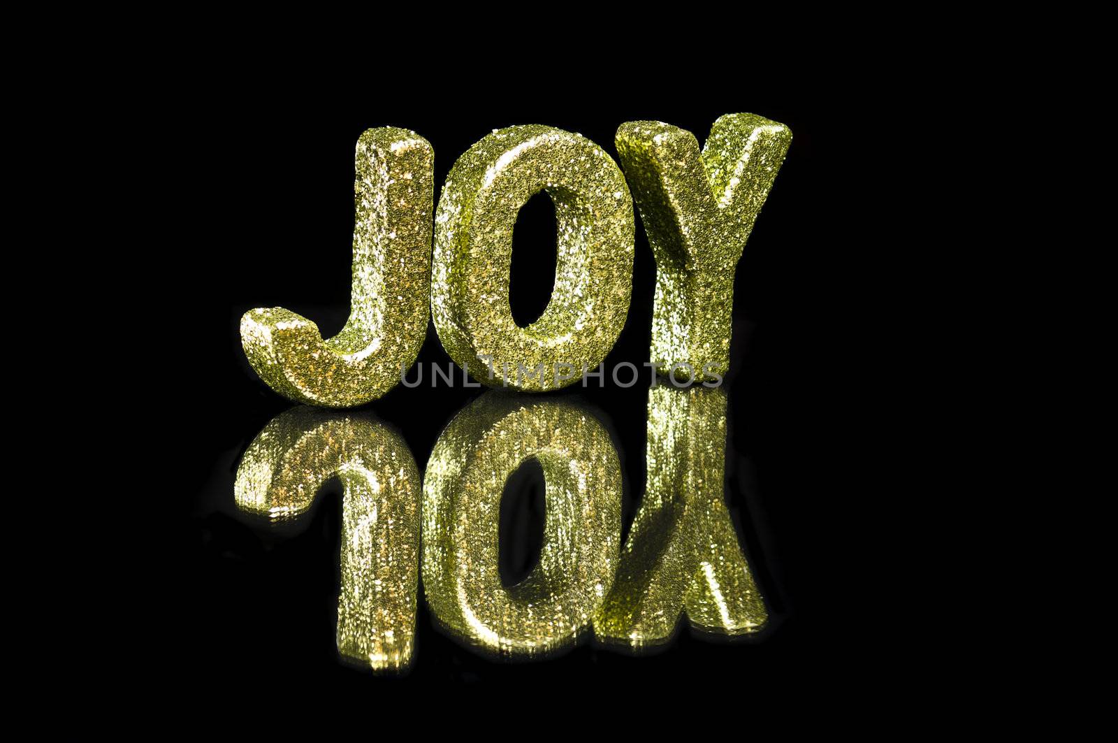 In capital letter written joy, glitter effect over black