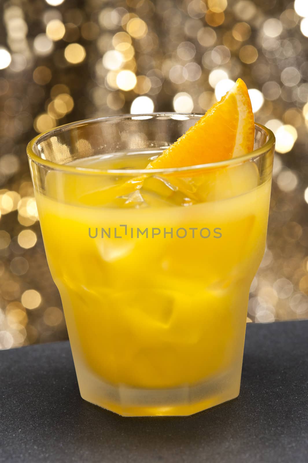 Screwdriver cocktail in front of different colored backgrounds