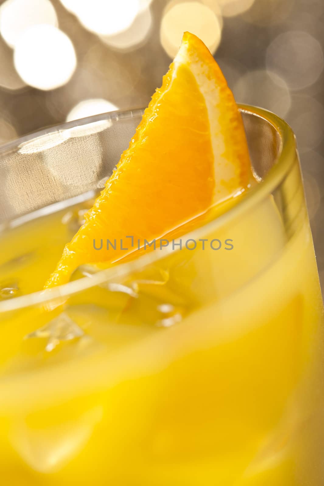 Screwdriver cocktail in front of different colored backgrounds