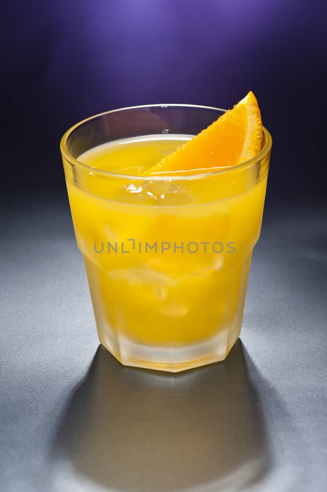 Screwdriver cocktail in front of different colored backgrounds