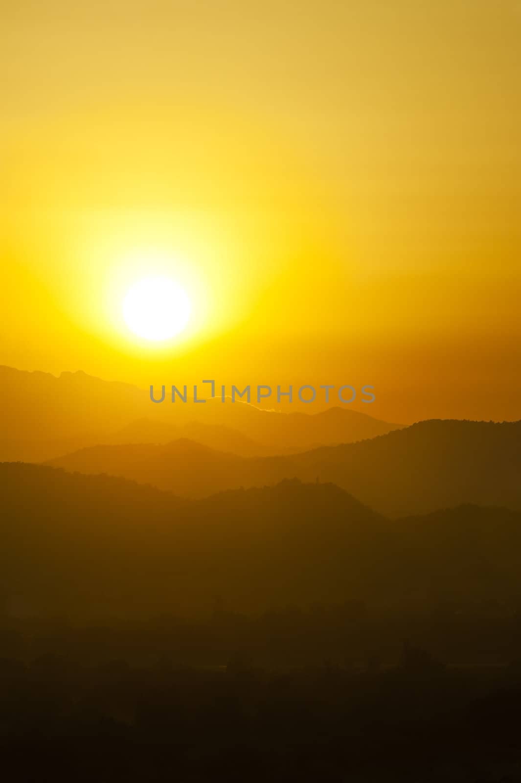 Sunset behind mountains with golden color