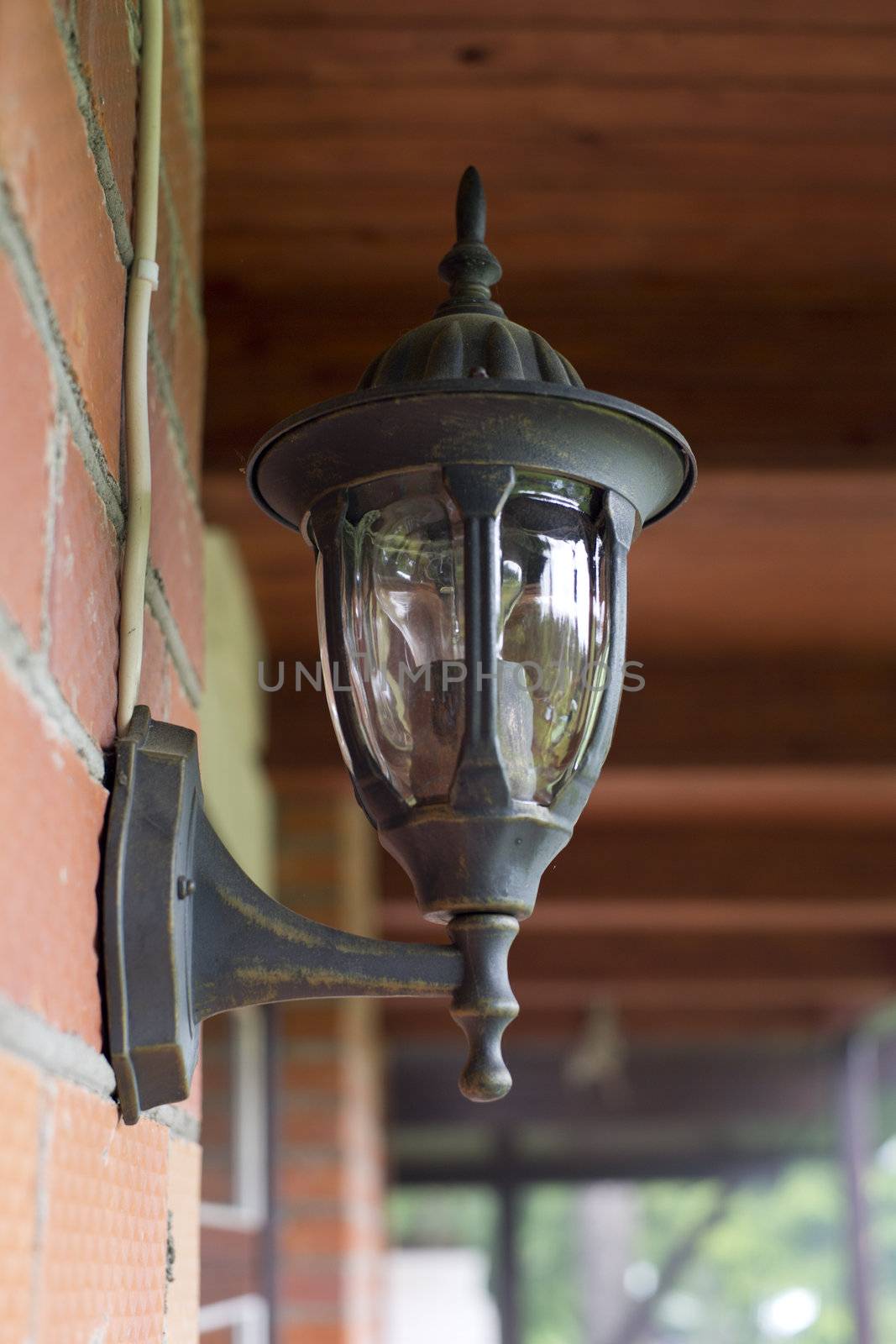 Lamp in retro style on brick wall by vetdoctor