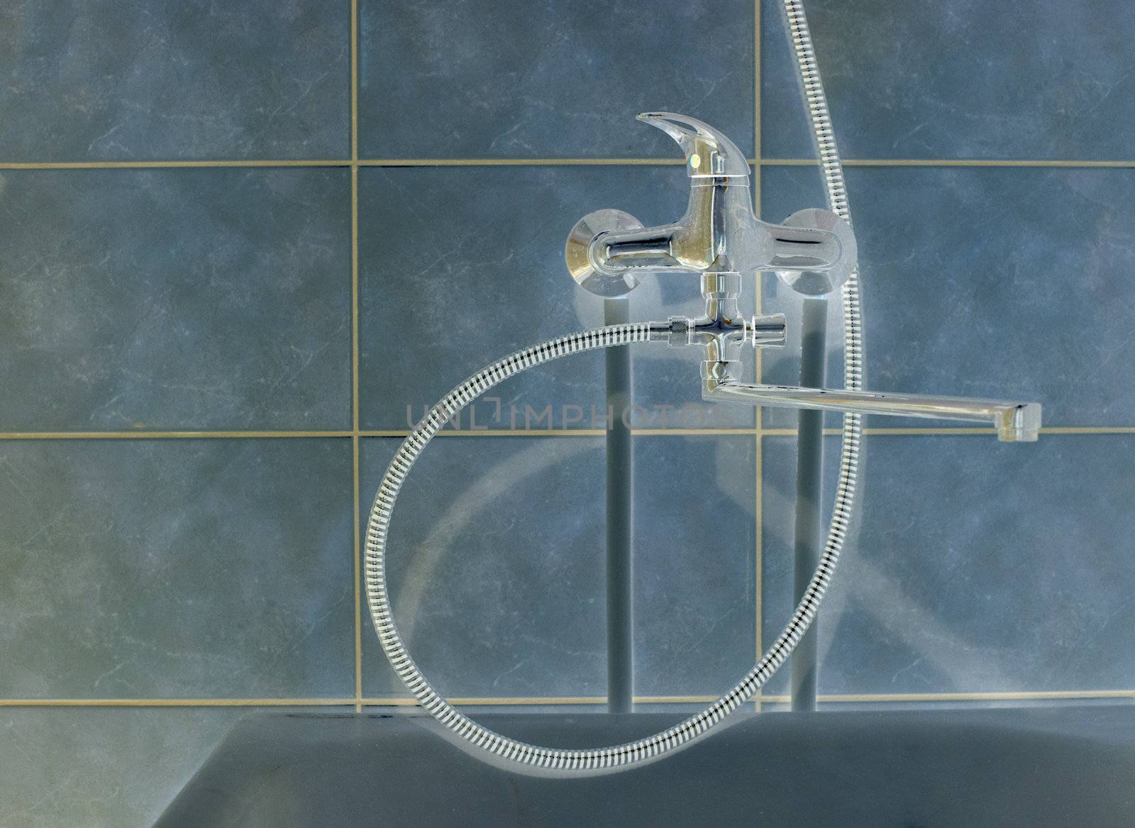 Shaded crome shower faucet turned to the right