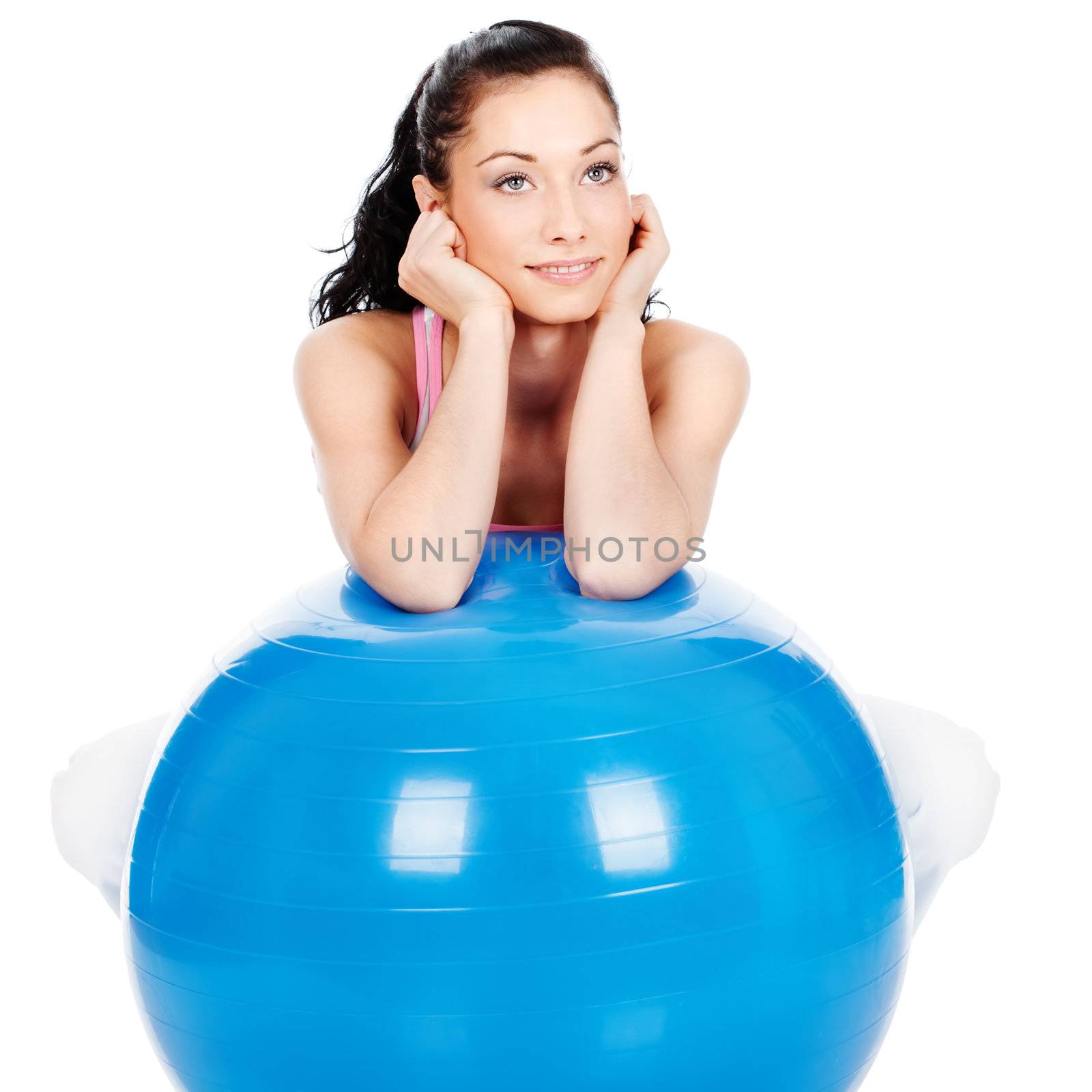 Pretty woman leaning on the big ball, isolated on white background