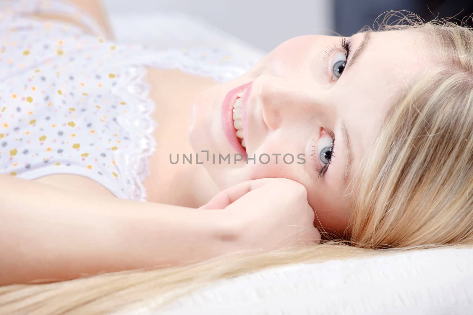 Cute blond girl on pillow  by imarin