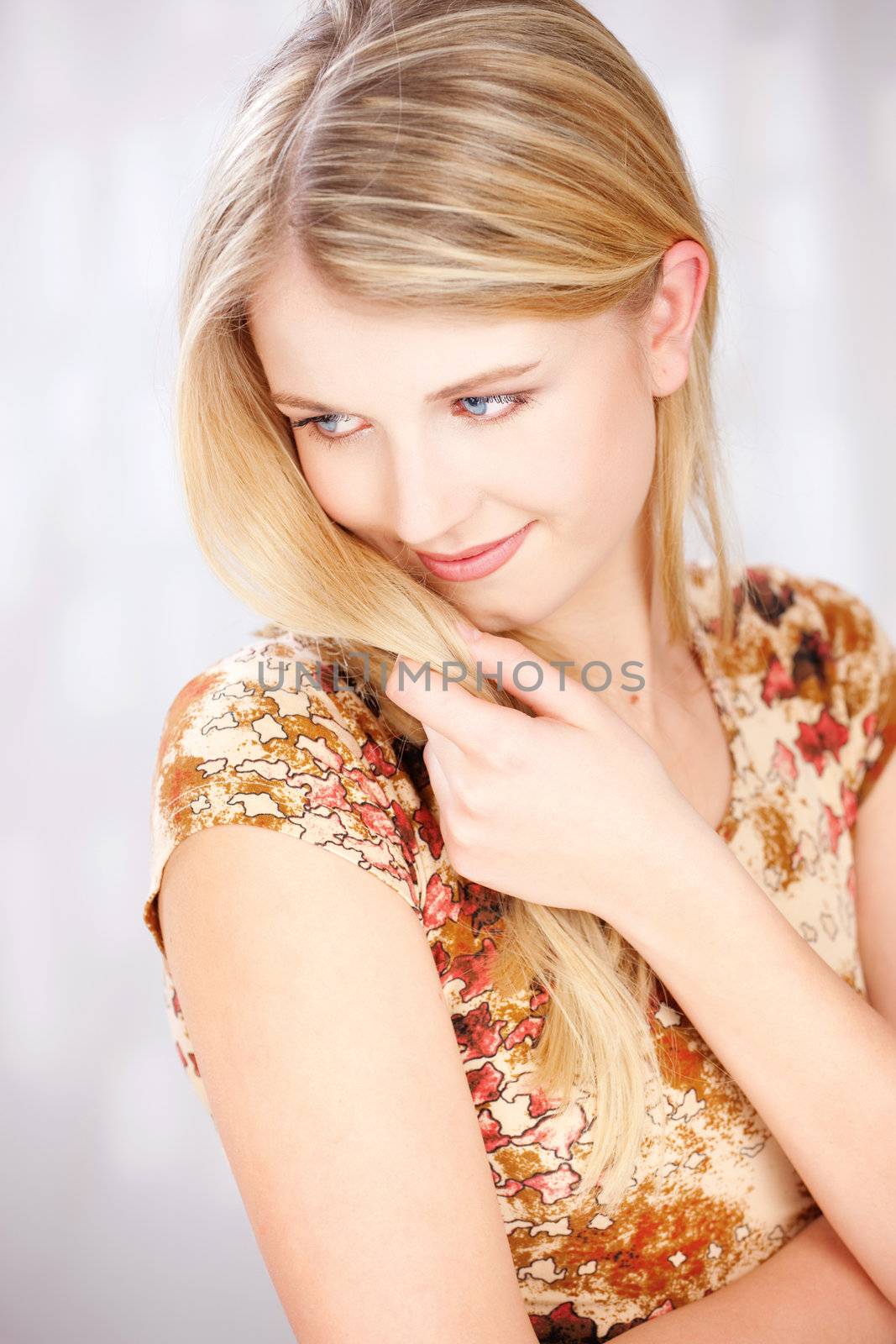 Cute blue eyes blond woman with little smile
