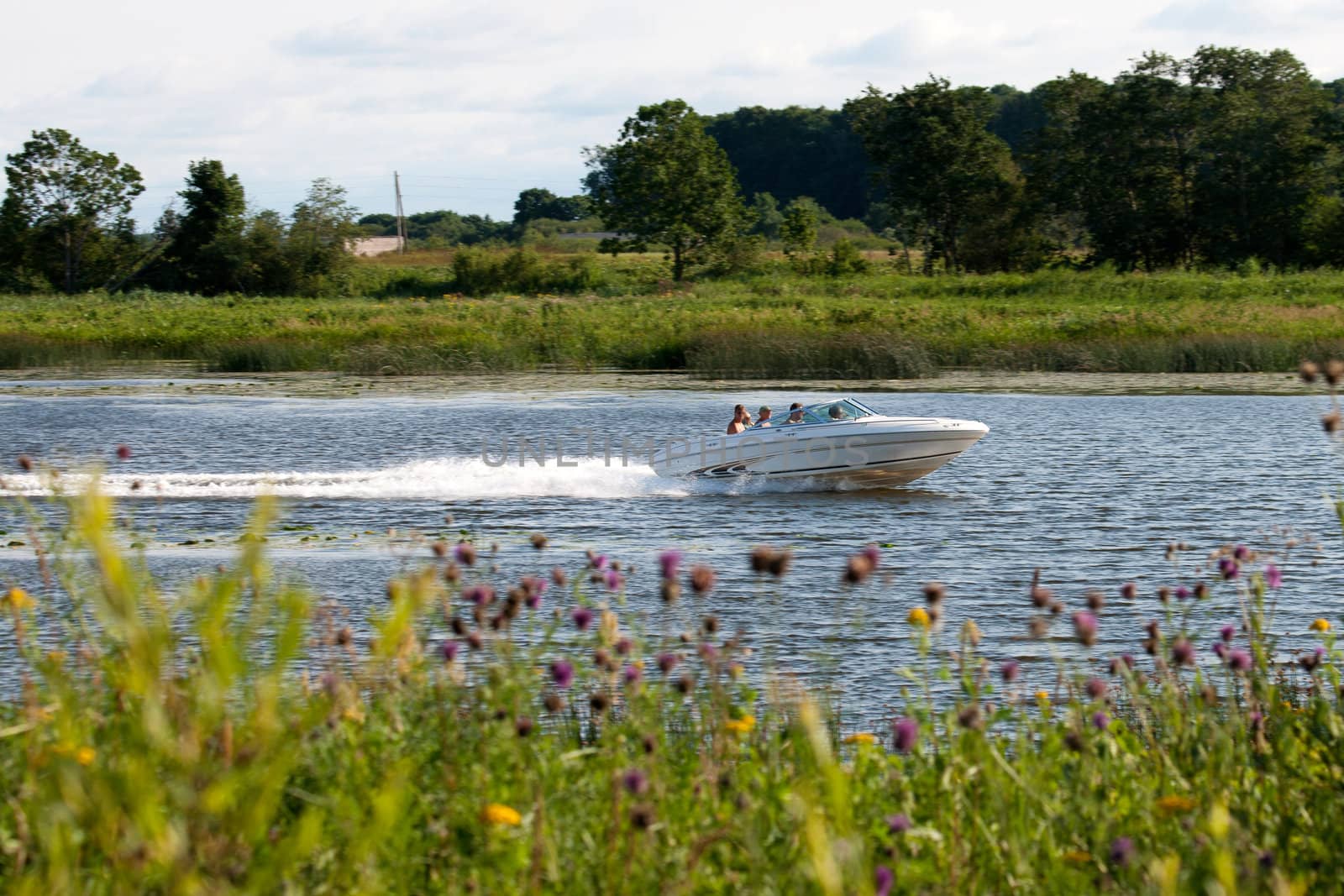 motor boat traveling along the river in the countryside