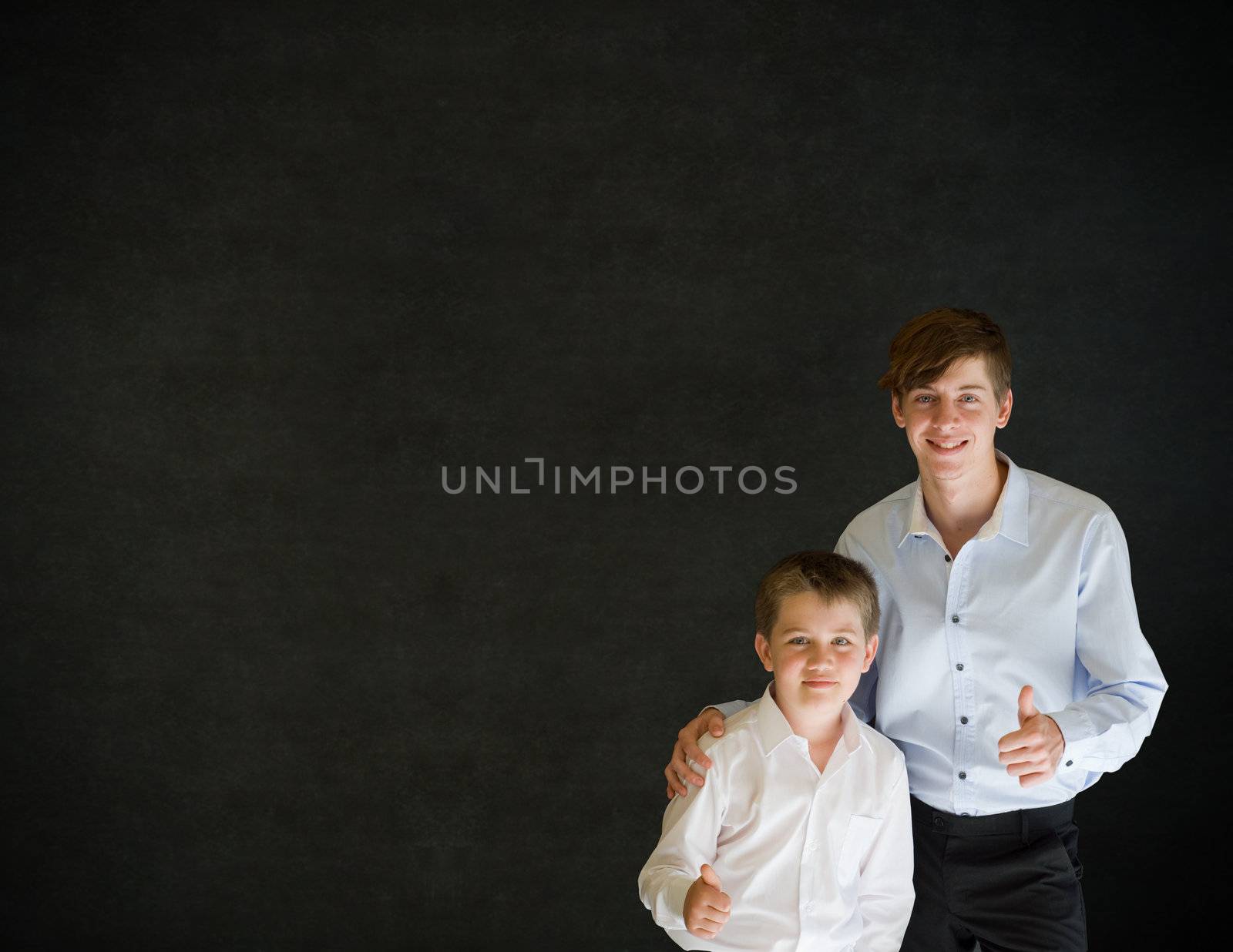 Teacher or student with boy dressed up as business man thumbs up on backboard background