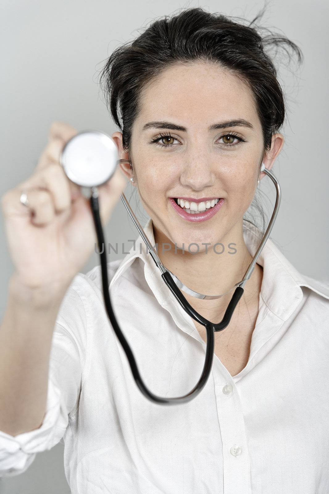 Female doctor using a stethoscope by studiofi