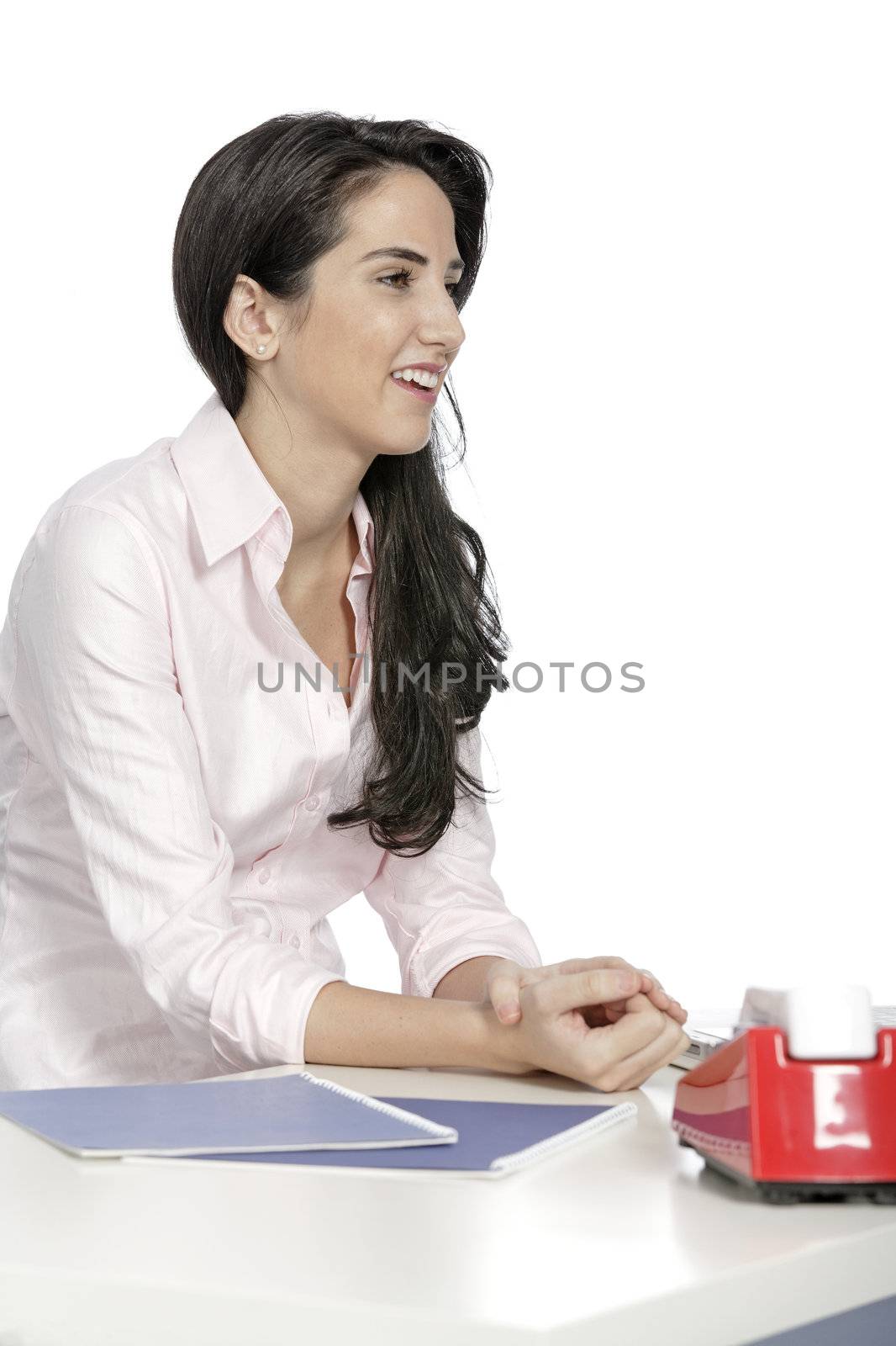 Attractive young woman sat at her desk with documents and telephone