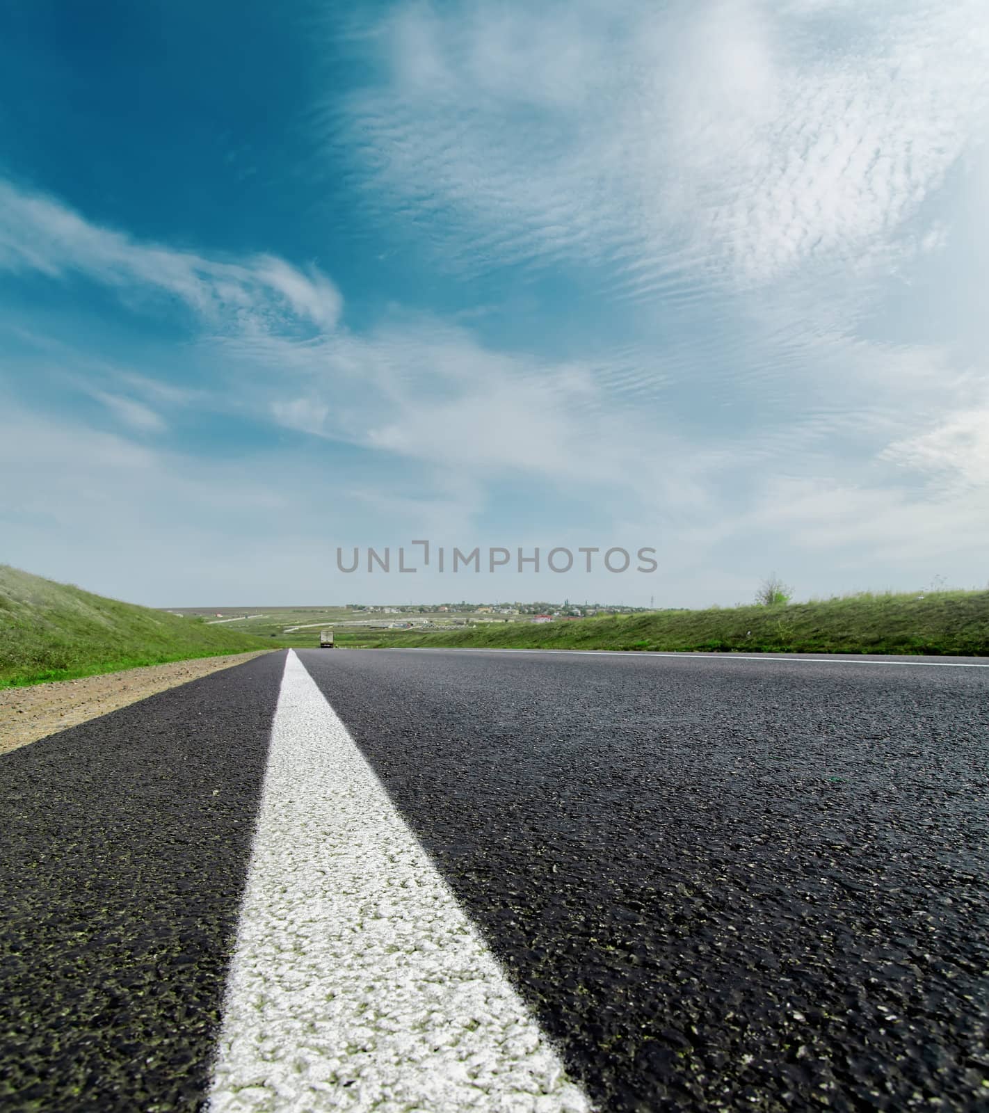 asphalt road closeup to cloudy horizon