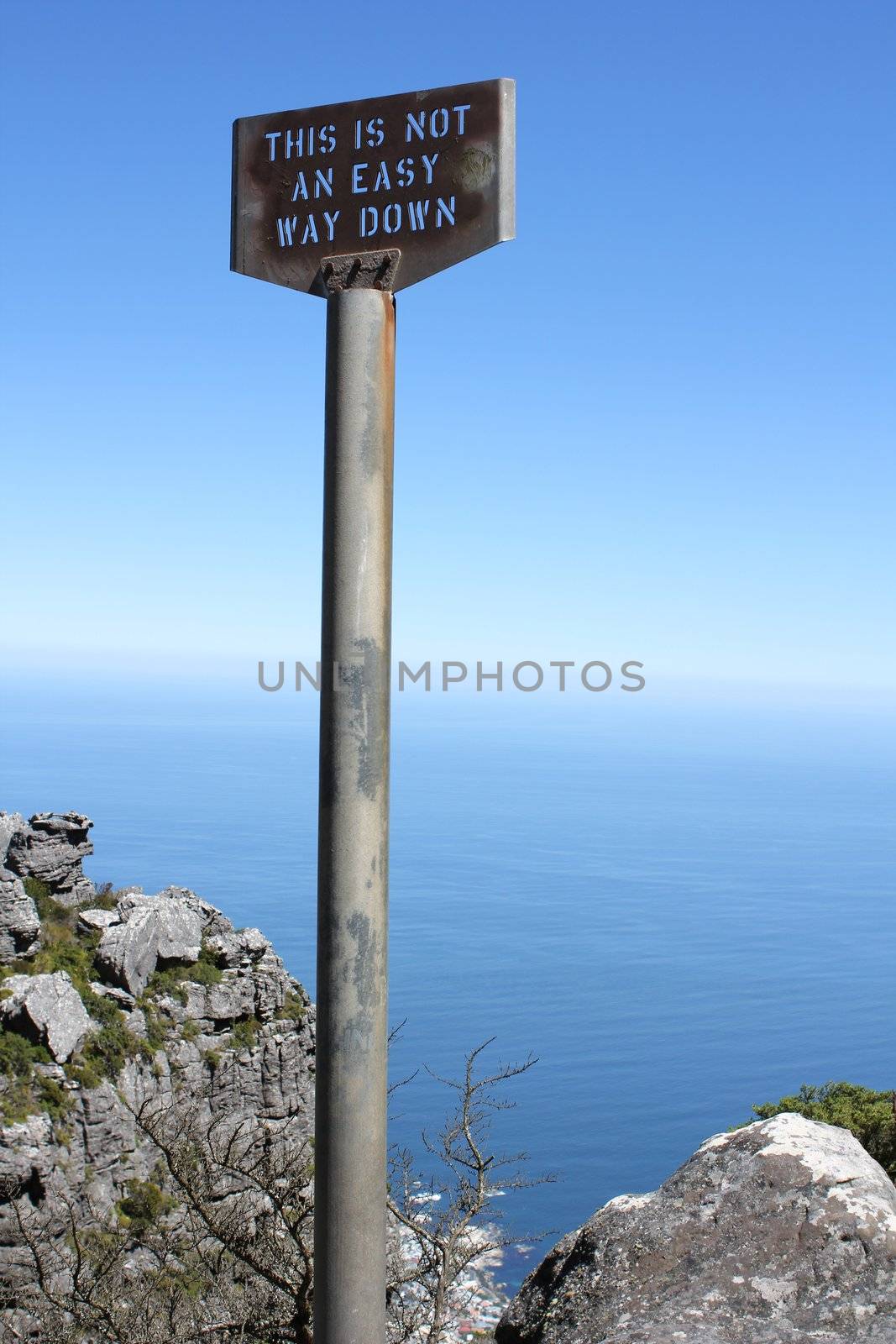 Old signpost on table mountain saying this is not an easy way down